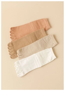 Flat lay of cotton five-finger socks in four neutral colors with ribbed cuffs for massage