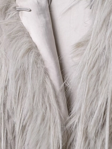 Detail of grey faux fur coat showing smooth satin lining and luxury texture