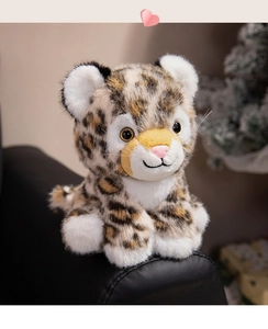 Close-up of leopard plush toy with realistic spotted faux fur on a cozy sofa armrest