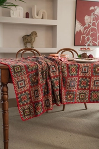 Close-up of red bohemian jacquard tablecloth featuring colorful geometric squares