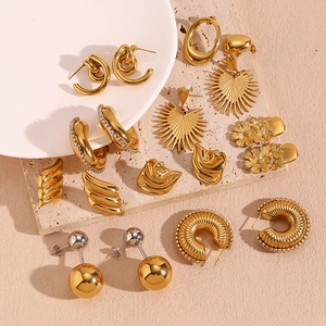 Selection of geometric 18K gold-plated irregular heart earrings on white ceramic