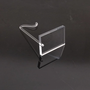 Detailed view of a clear acrylic jewelry display stand with a support rod on black background