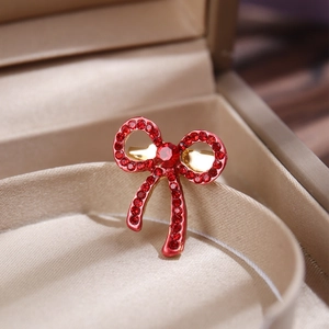 Macro detail of red rhinestone butterfly brooch with elegant gold metal setting
