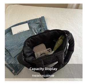 Close-up of black quilted hobo bag interior showing large capacity for daily essentials