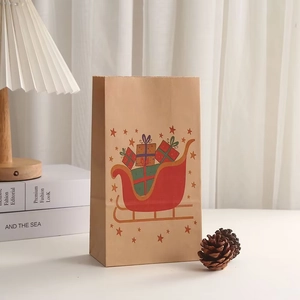 Christmas kraft paper gift bag featuring red sleigh and present box holiday patterns