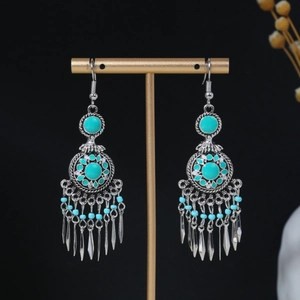 Close-up of bohemian tassel earrings with turquoise beads and silver dangles