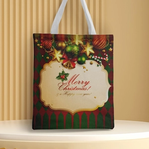 Detail view of canvas tote bag featuring Christmas patterns and festive holiday greetings