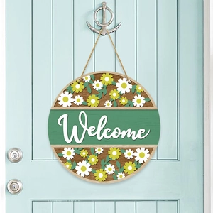 Round wooden welcome sign with white daisies and green accent for farmhouse door decor