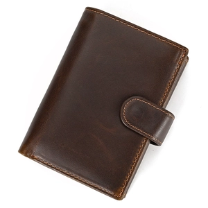 Detailed close-up of dark brown genuine leather wallet with fine stitching and grain texture