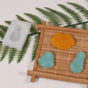 Detailed silicone mold for DIY Buddha and longevity lock resin pendants with finished pieces