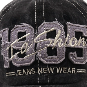 Nahaufnahme der 1985 Bestickung auf der gewaschenen Baseballkappe aus Denim Baumwolle