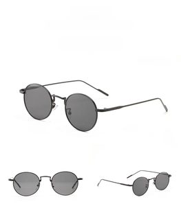Three-view display of vintage round metal sunglasses with black frames and grey lenses