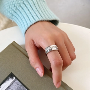 Close-up of irregular textured S925 silver ring worn on index finger for elegant style