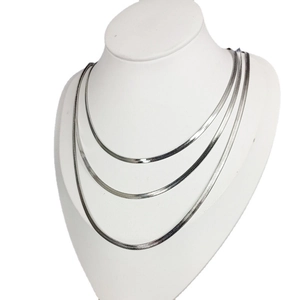 Three-layer silver snake bone chain necklace set on model with metallic finish