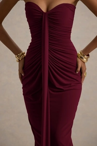 Close-up of the elegant ruched draping and slim-fit texture on the wine red dress