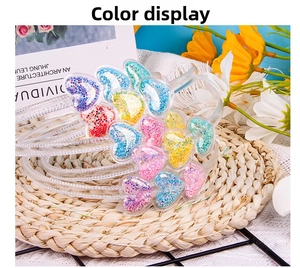 Detail of transparent children's headbands featuring colorful glitter heart charms