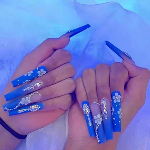 Long square royal blue press-on nails with white flower and rhinestone decorations