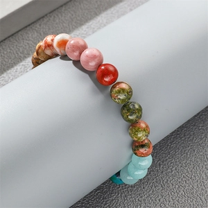 Colorful natural agate and map stone beaded bracelet on a grey display cylinder