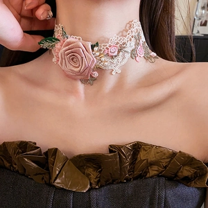 Close-up of beige lace choker with pink fabric roses and pearl accents on a model