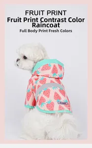 Detail of pink strawberry print dog raincoat with mint green trim and reflective back safety strip