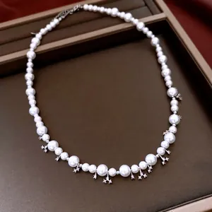 Elegant pearl choker necklace with snowflake pendants and adjustable metal chain