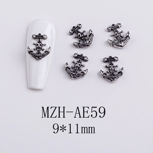 Detail of vintage silver anchor skull nail charms for gothic Halloween manicure art