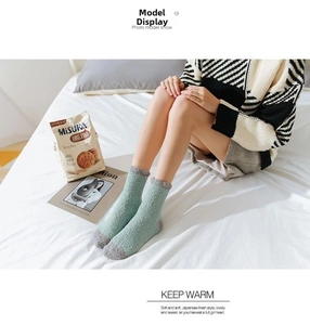 Close-up of mint green coral fleece socks with thick thermal fabric for home comfort