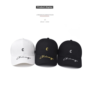 Close-up of embroidered C and Chicago script on cotton baseball caps in black and white