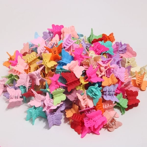 Detailed macro view of colorful matte butterfly hair clips in various macaron shades