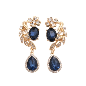 Vintage floral drop earrings with blue rhinestones and gold-plated finish on white background