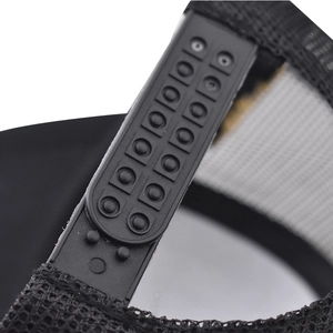 Detail of adjustable snapback closure and mesh material on black cotton baseball cap