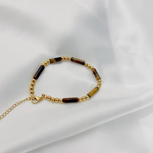 Detail of beaded vintage natural stone bracelet with gold beads and lobster clasp