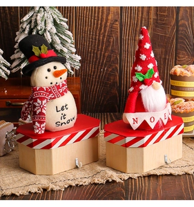 Festive Christmas candy boxes with snowman and gnome plush dolls for holiday decoration