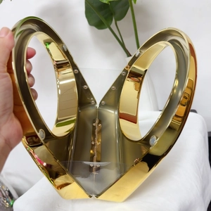 Detail of the open golden heart-shaped evening clutch bag with metal hinge structure