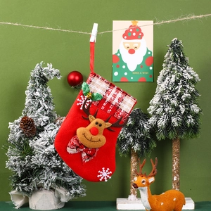Detail of red Christmas stocking with reindeer head and snowflake pattern hanging on a rope