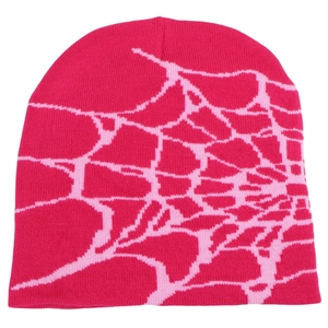 Detail of fuchsia knit beanie featuring a pink spider web jacquard pattern and texture