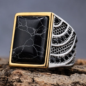 Vintage men's stainless steel ring featuring a black turquoise stone and gold accents