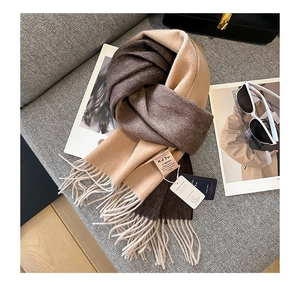 Close-up of premium goat wool scarf texture with elegant gradient and fringe detail
