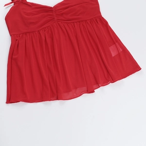 Detail of red mesh camisole featuring ruched fabric and delicate bow shoulder straps