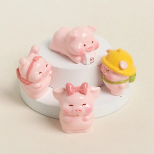 Set of four cute resin pink pig figurines in various poses on a white display stand