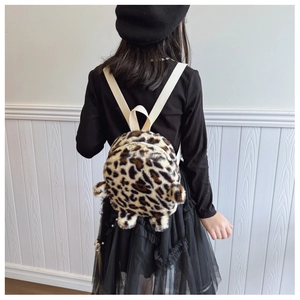 Detail view of toddler leopard plush backpack with ear accents and white straps
