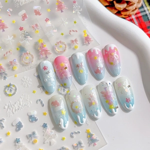 3D Christmas nail stickers with snowflakes and trees on pink and blue gradient nails