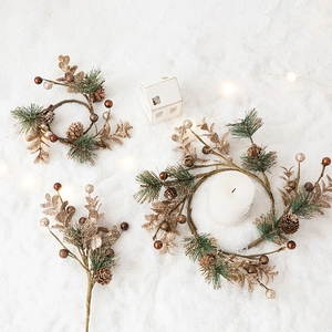 Golden pinecone Christmas wreath with needles and sparkling ornaments on snowy background