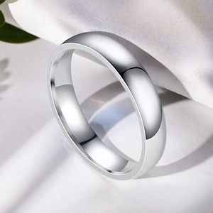 Classic silver titanium steel dome ring with a polished finish on white silk background