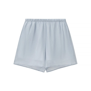 Detail of light blue textured shorts featuring an elastic waistband and minimalist design