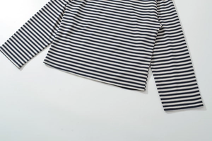 Detail of classic blue and white striped long sleeve tee showing knit texture and hem