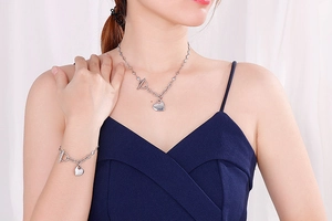 Detailed view of silver heart pendant necklace and bracelet set with T-bar toggle clasp