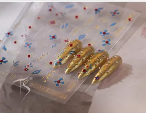 Close-up of TL-248 3D relief nail stickers with golden clouds and blue floral patterns