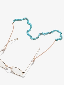 Detail of natural turquoise beads and gold chain on glasses strap with silicone loops
