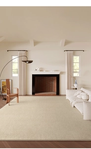 High-quality beige flat-weave rug shown in a modern living room with fireplace and sofa